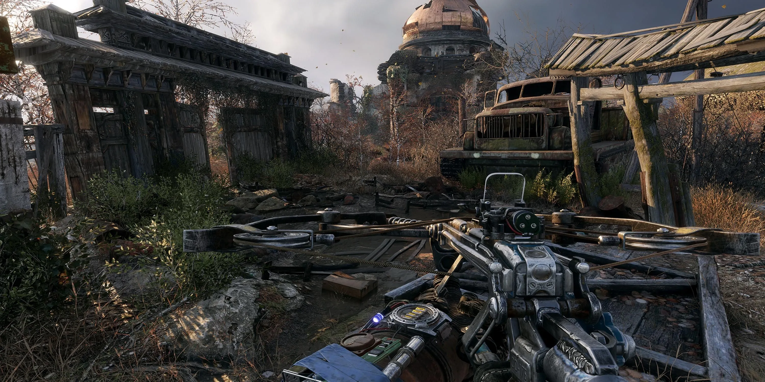 Cảnh nhìn ra những tòa nhà đổ nát trong Metro Exodus, tay cầm súng.